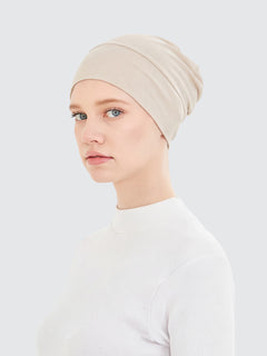 Imaarah sand beige hijab undercap showing smooth stretch fit and coverage