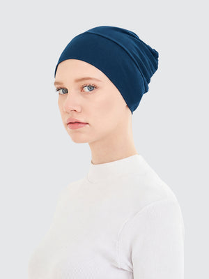 Imaarah teal hijab undercap showing soft stretch fit and smooth coverage