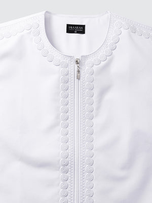 Close up of intricate imperial Moroccan embroidery on white thobe, showcasing fine craftsmanship and traditional hand finished detailing