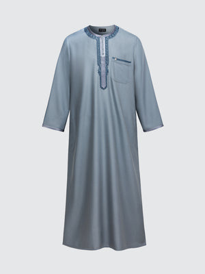 Moroccan long sleeve thobe set in slate blue with blue embroidery by Imaarah, featuring Moroccan neckline detailing and matching pants