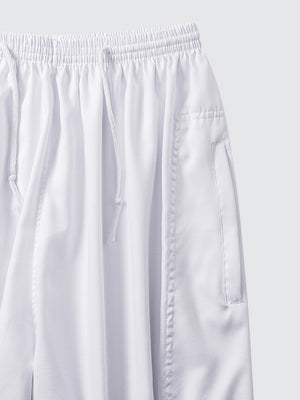 Close-up of Imaarah Andalus white pants waistband with adjustable drawstring and soft breathable fabric