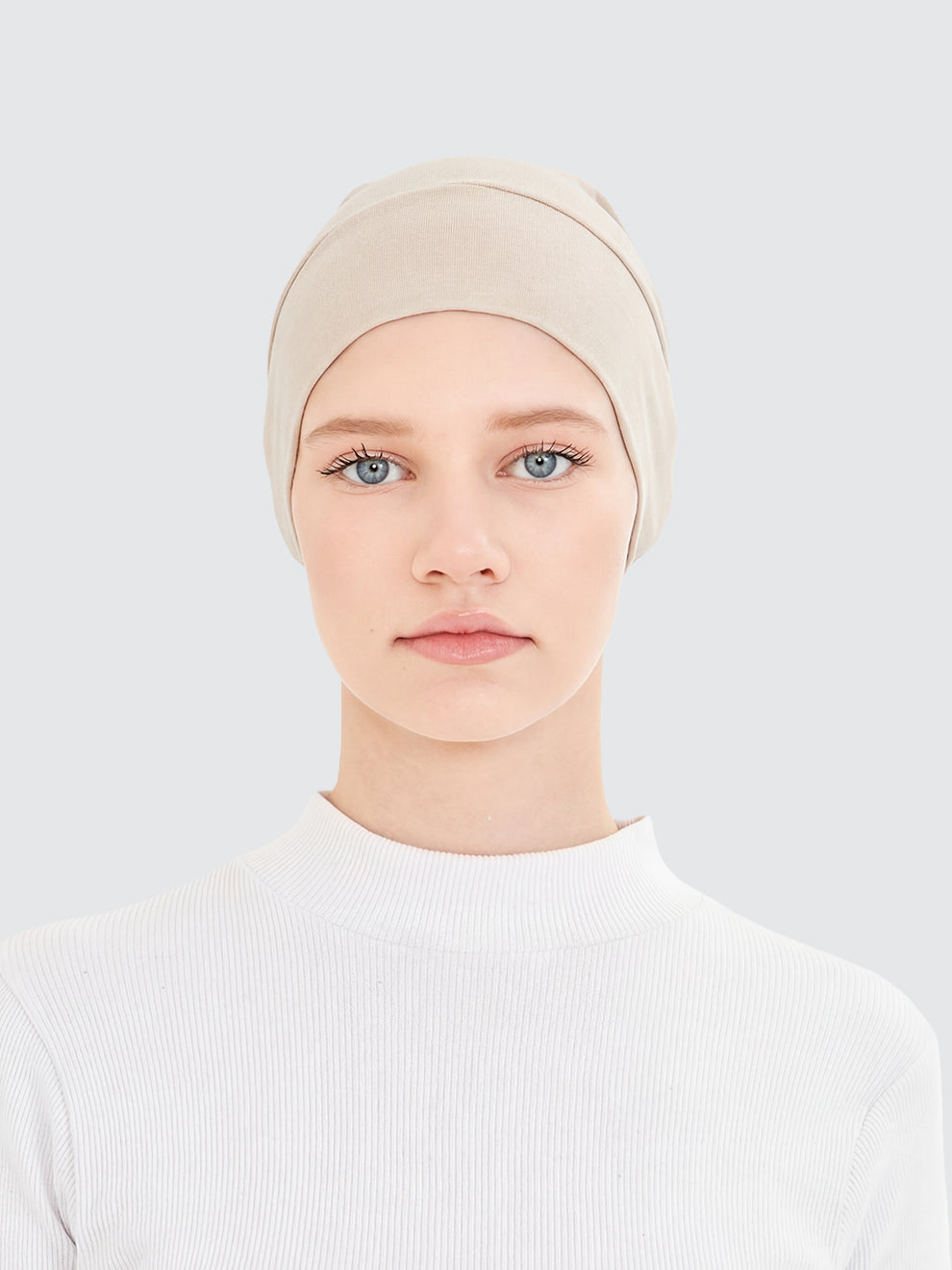 Woman wearing the Imaarah hijab undercap in sand beige