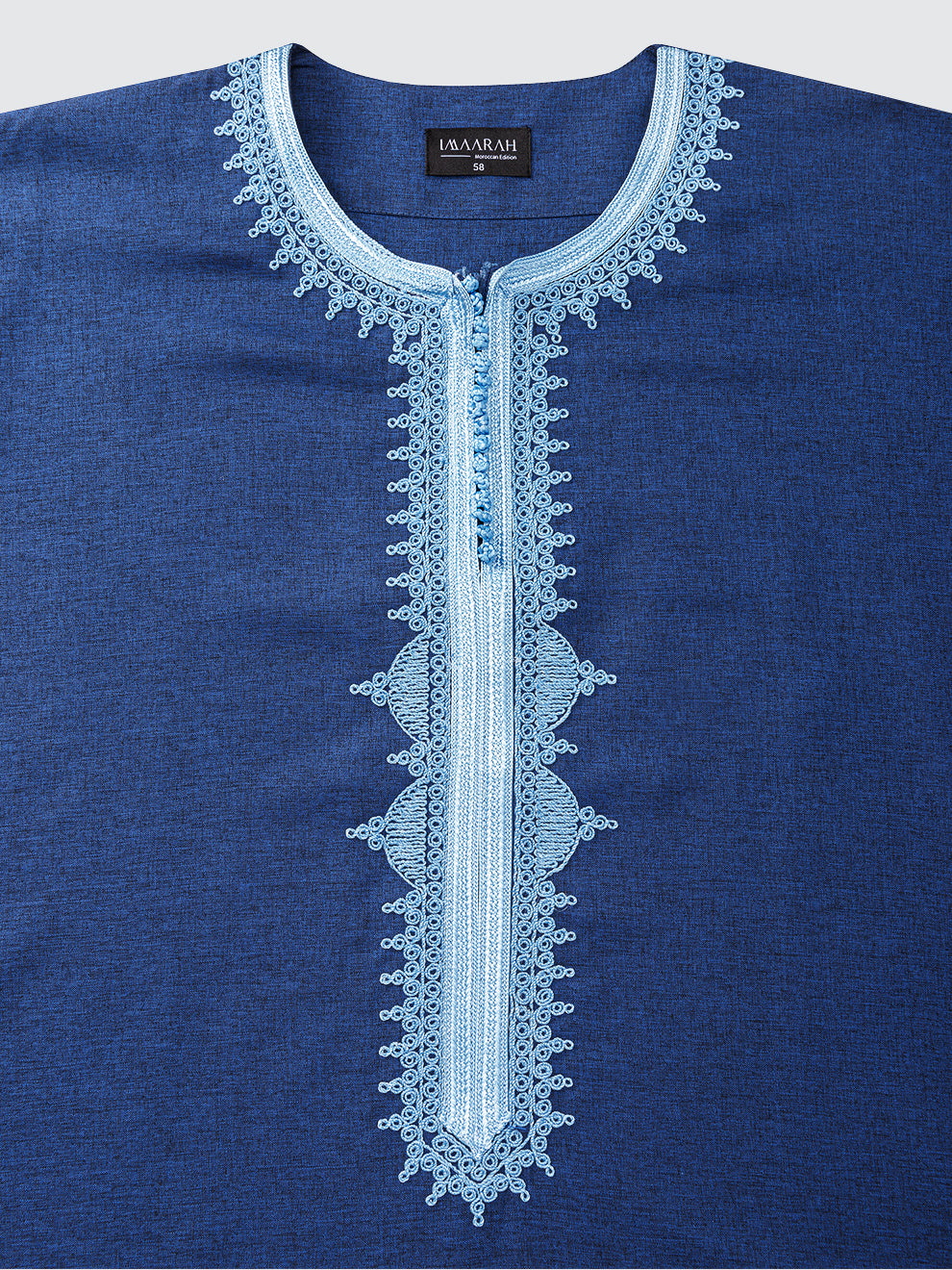 Close view of the Imaarah Qasr Moroccan short sleeve thobe in navy with ice blue embroidery