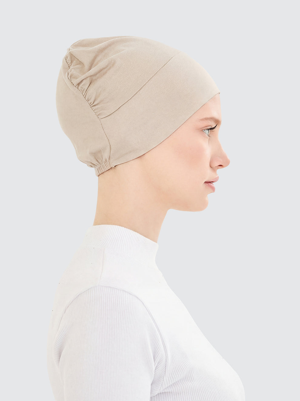 Imaarah sand beige hijab undercap side view with lightweight flexible design