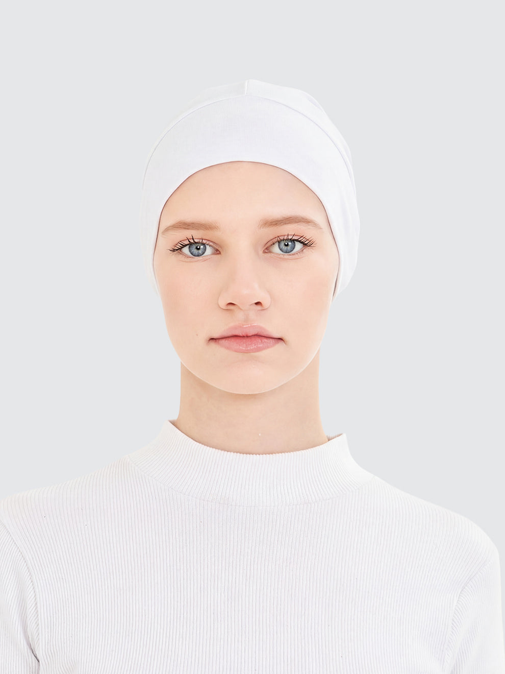 Imaarah white hijab undercap worn as lightweight base layer for modest styling