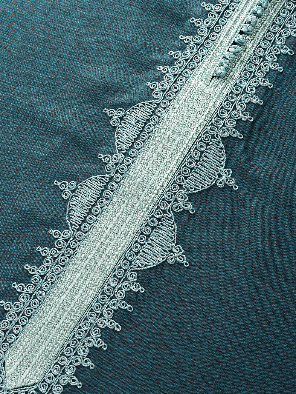Seafoam green Moroccan-inspired embroidery detail on emerald green thobe fabric