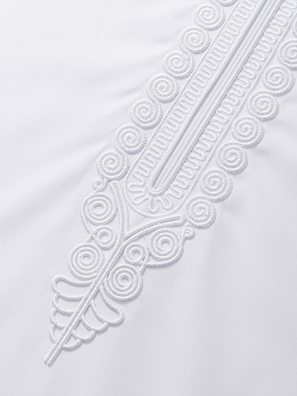 Detailed view of imperial Moroccan embroidery on white thobe placket, highlighting luxury stitching and ceremonial design elements