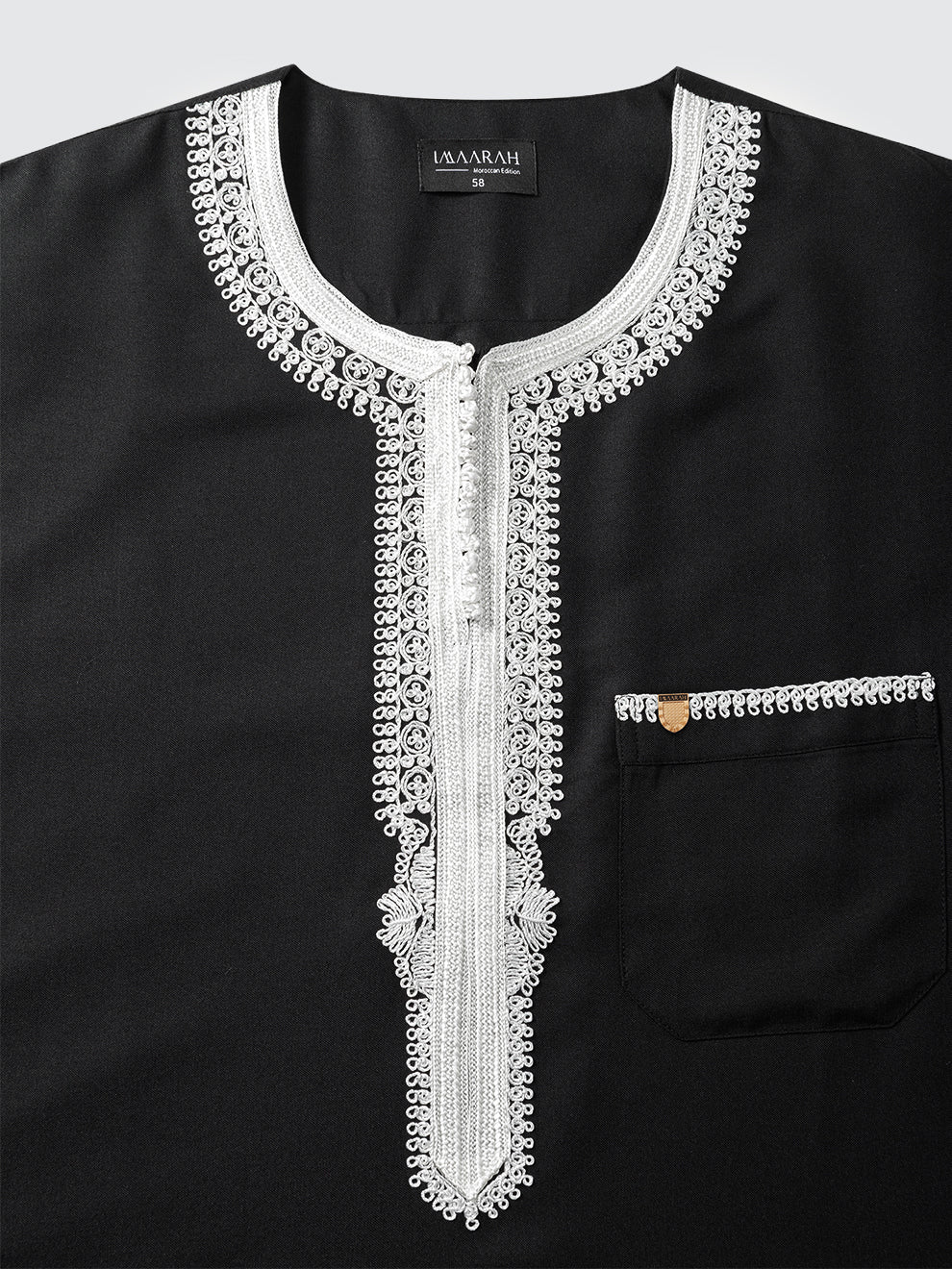 Top view of Imaarah Andalus Moroccan thobe neckline in black with white Moroccan embroidery and concealed front placket