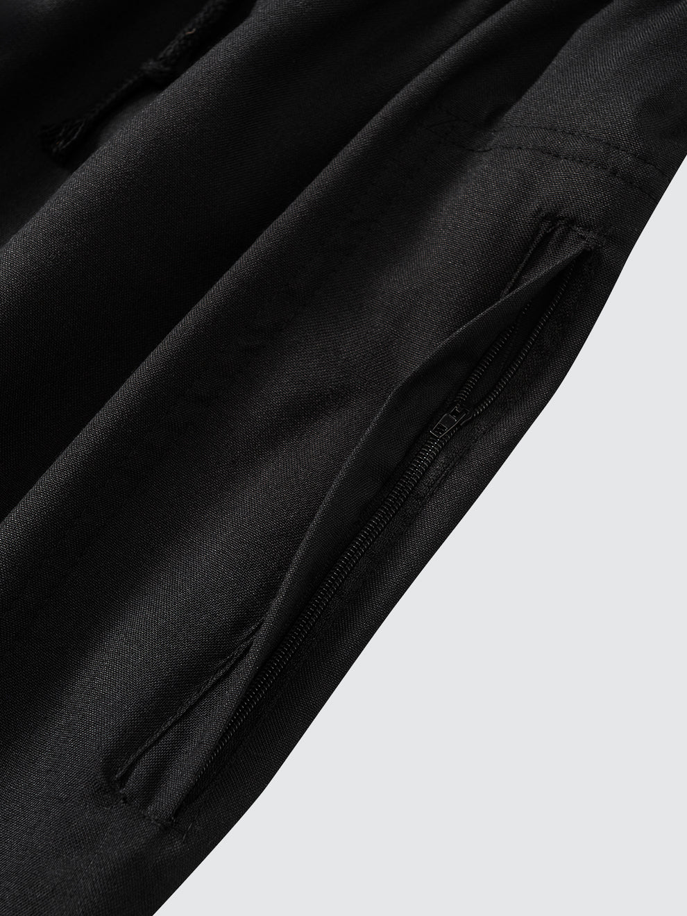 Close-up of Imaarah Andalus black pants side pocket with concealed zip closure for secure everyday wear