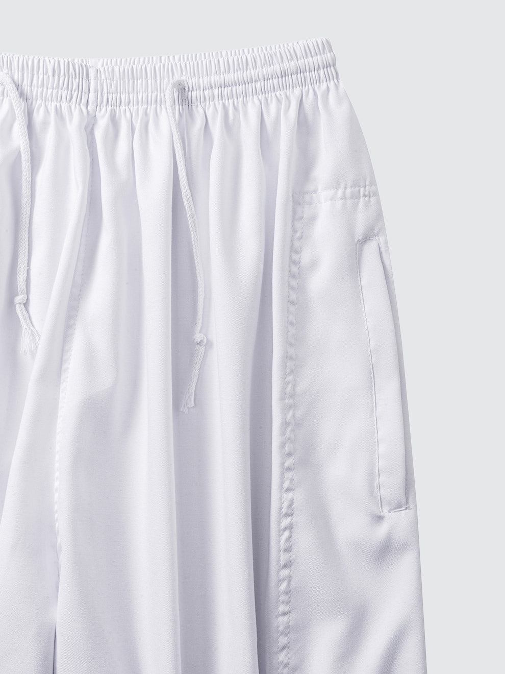 Close-up of Imaarah Andalus white pants waistband with adjustable drawstring and soft breathable fabric