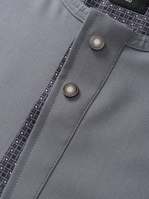Close-up of Imaarah Vantage grey short sleeve thobe buttons and textured fabric detail